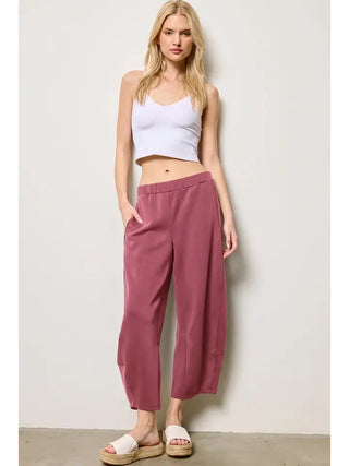Model wearing dark mauve barrel pants with a relaxed fit.
