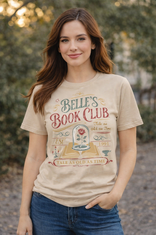 Woman wearing a 'Belle's Book Club' t-shirt with a forest background