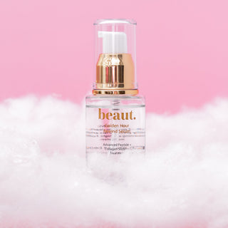 Golden Hour Rewind Serum bottle with a pump dispenser on a pink background.