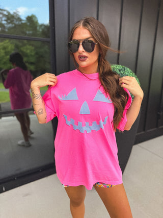 Checkered Pumpkin Face Graphic Tee on Neon Pink