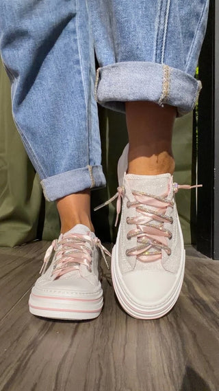 White glitter slip-on shoes with pink laces and a cushioned footbed.