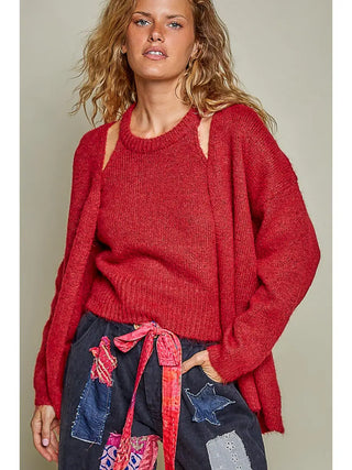 A woman wearing a red wine ribbed cardigan top set with a relaxed fit.