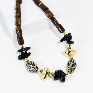 Necklace with brown, black, and leopard print beads, featuring gold-tone accents.