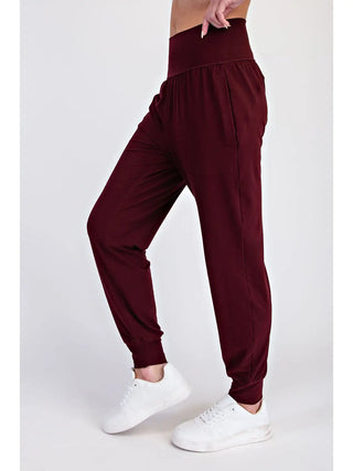 Side view of dark cherry joggers with a high-rise waistband and side pockets.