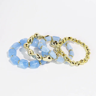 Set of blue and gold bracelets featuring blue beads and gold-tone accents.