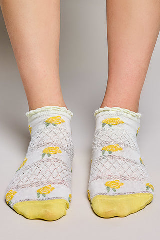 White ankle socks with yellow floral pattern and ruffled trim.