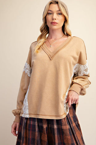 A camel-colored pullover with lace detailing at the sleeves and sides, featuring a V-neckline and relaxed fit.
