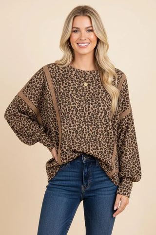 Oversized taupe top with leopard print and ribbed knit texture, worn by a model.