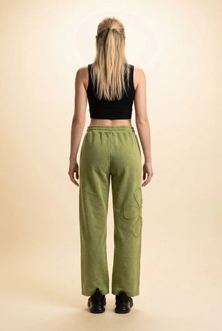 Olive wide leg pants with drawstring waist, worn by a model standing backwards.