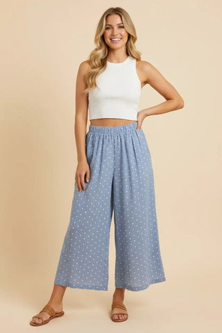 Light denim wide-leg palazzo pants with a polka dot pattern and elastic waistband.