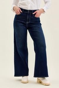 High waist wide leg jeans in twilight blue, designed for petites, shown on a model.