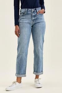 A person wearing light iced indigo boyfriend jeans with a relaxed fit and cuffed hems.