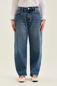 Front view of Petite Marlow Arc Jeans in time weathered indigo, worn with a white shirt and flats.