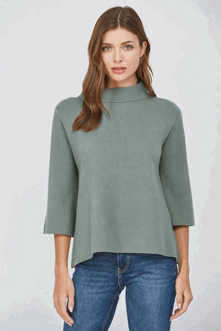 Sage green mock neck pullover sweater with bell sleeves worn by a model.
