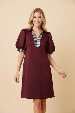 Burgundy short sleeve shift dress with plaid neckline and sleeve cuffs.