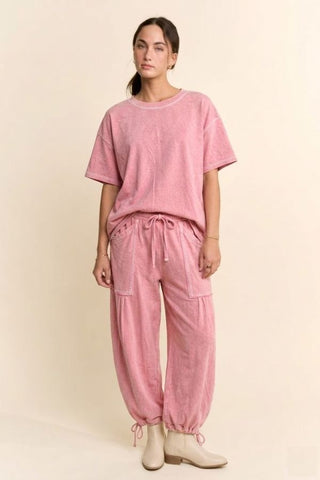 A model wearing a pink washed boxy tee and tie-hem balloon pants set.