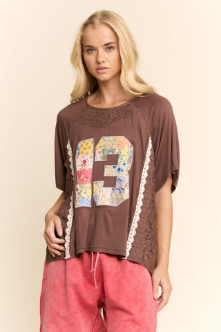 A mocha brown varsity knit top with lace trim, featuring a relaxed fit.