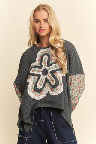 A waffle knit top in sea foam with floral sleeves and a relaxed fit, worn by a model.