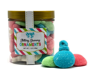 A jar of sanded gummy ornaments in assorted colors with a gold lid.