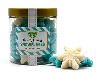 Sanded gummy snowflakes in a clear jar with a gold lid, featuring blue and white candies.