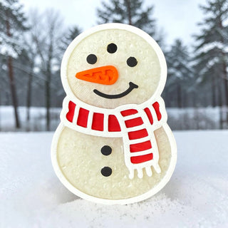 A medium snowman freshie with a red scarf and orange nose, set in snowy surroundings.