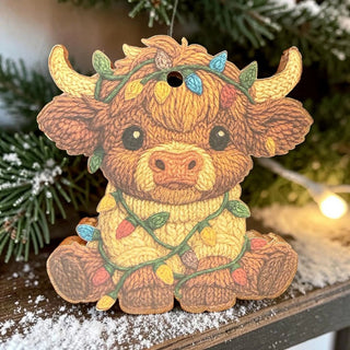 A cute cow-shaped freshie wrapped in colorful lights with a snowy background.