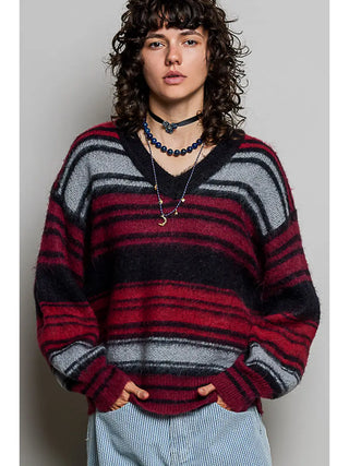 A black multi-stripe V-neck sweater with balloon sleeves worn by a model.