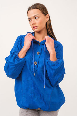 A royal blue jacquard knit top with a hood and button details.