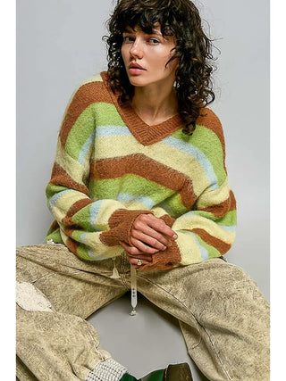 A V-neck sweater with balloon sleeves and a choco multi stripe pattern worn by a model.
