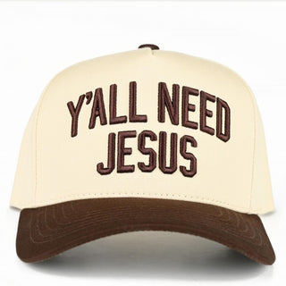Two-tone canvas baseball cap in cream and brown with 'Y'all Need Jesus' embroidered on the front.
