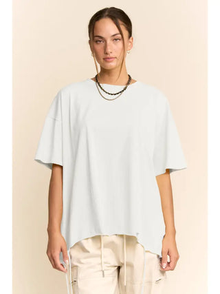 A white oversized tee with a drawstring hem worn by a person.