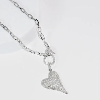 Silver necklace with a heart-shaped pendant and link chain design.