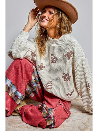 Cream chenille sweater with festive patterns, featuring a cropped fit and long sleeves.