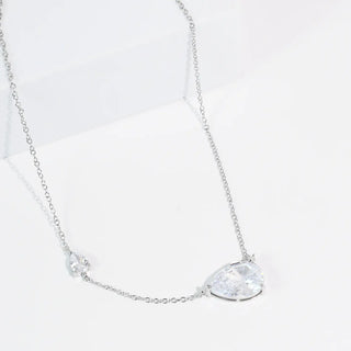 Silver necklace with two drop pendants on a delicate chain.