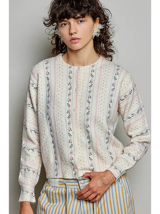 A cream knit cardigan with a vintage floral stripe pattern, featuring a crew neckline and button front closure.