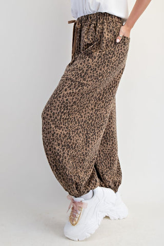 Animal-printed washed terry pants in mocha with a relaxed fit, shown with white sneakers.