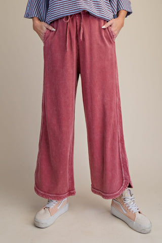 Mineral washed terry knit pants in wine, featuring a relaxed fit with wide legs and drawstring waist.