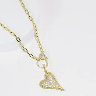 Gold necklace with a heart-shaped pendant and clip closure.