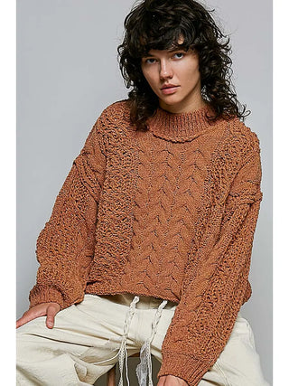 Cable knit pullover sweater in burnt topaz with a mock neck and relaxed fit.