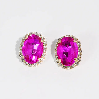 Fuchsia stud earrings with faceted stones in a prong setting.