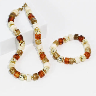 Necklace and bracelet set with earthy-toned beads and gold accents.