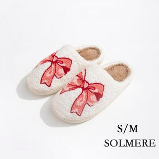 Plush pink slippers with a leopard print and bow design, shown in S/M size.