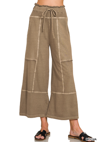 Mocha wide leg pants with exposed seams and drawstring waist.