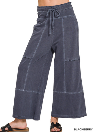 Wide leg French terry pants in blackberry with exposed seams, shown on a model.