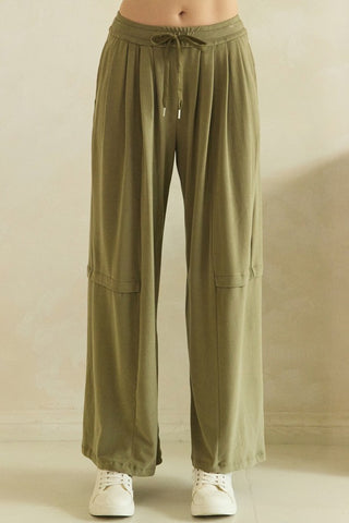 Olive wide-leg flowy pants with elastic waistband and drawstring.