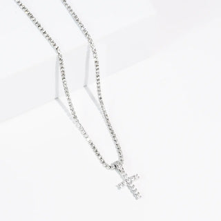 Silver necklace with a crystal cross pendant on a white background.