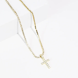 Gold necklace with a crystal-embellished cross pendant on a box chain.