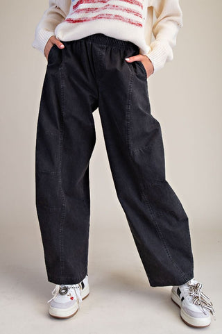 Black loose fit pants with an elastic waistband, styled with a cozy sweater and sneakers.