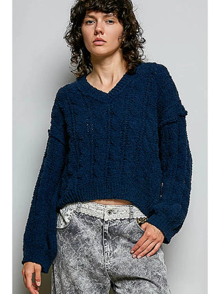 A navy semi-cropped V-neck sweater with textured knit worn by a model.