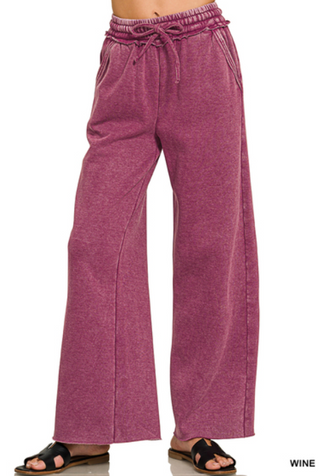 Wine-colored acid wash fleece palazzo sweatpants with side pockets.